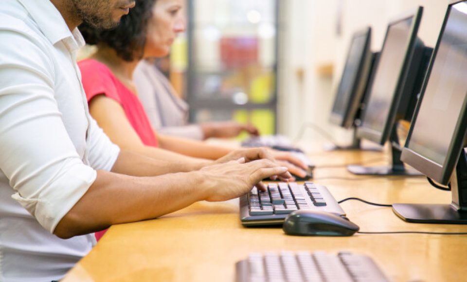Multiethnic group of students working in computer class