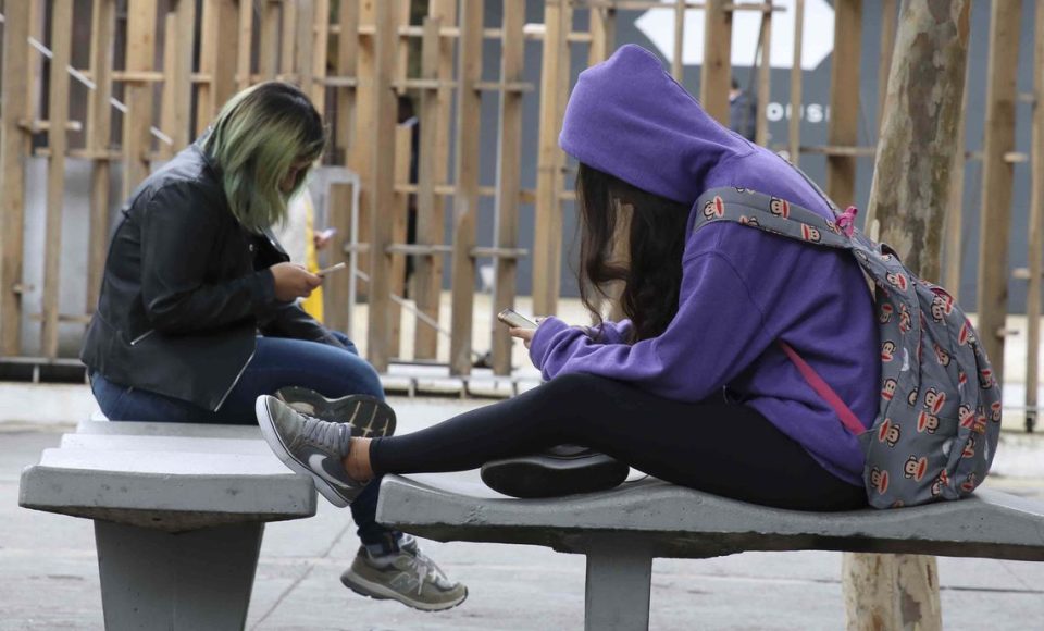 Uso contínuo de celular com  a cabeça inclinada para baixo pode gerar problemas na cervical.